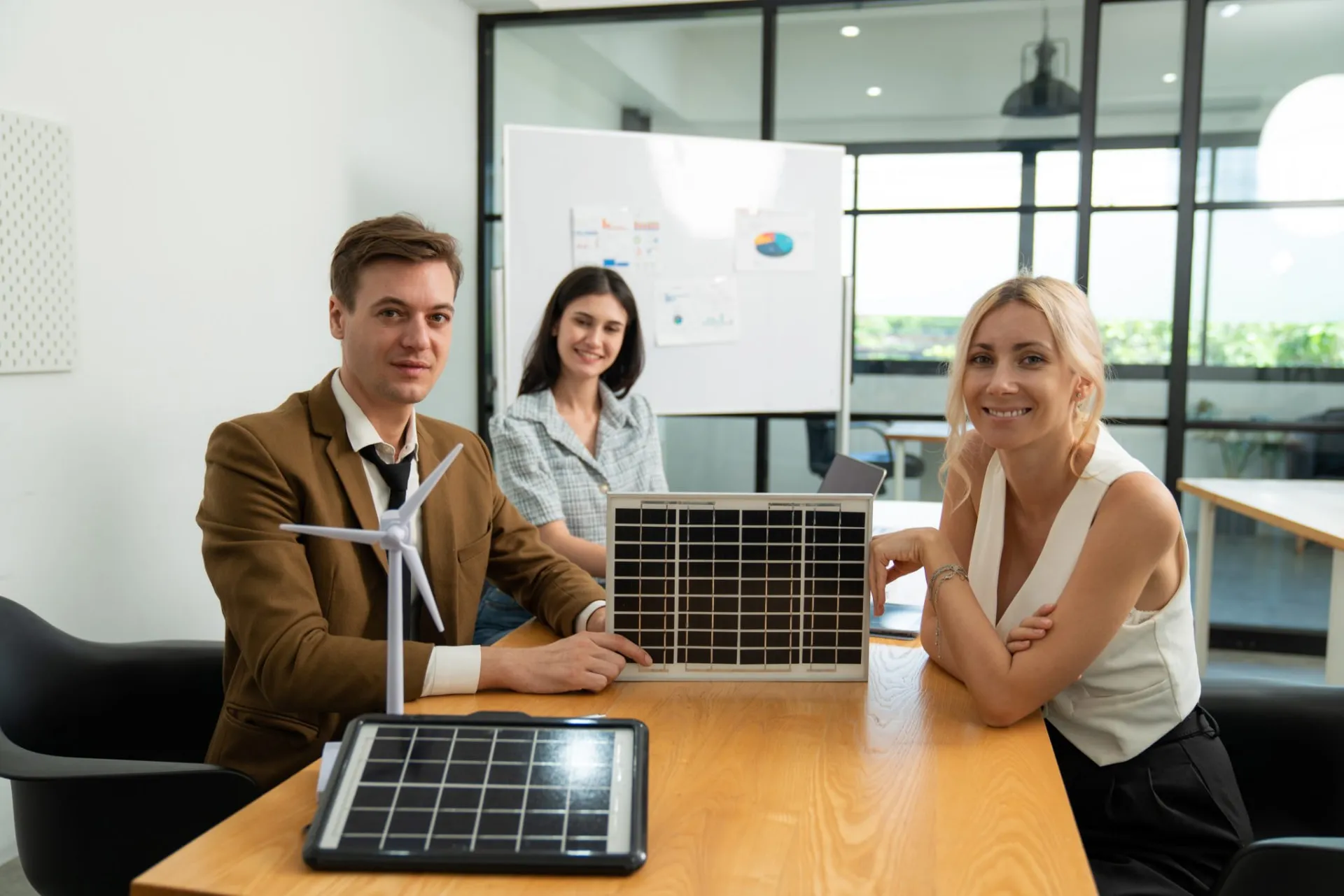 Business team reviewing solar energy savings in a meeting room