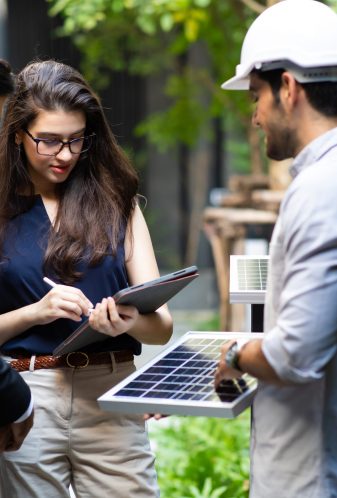 Energy consultants reviewing a commercial solar proposal on site
