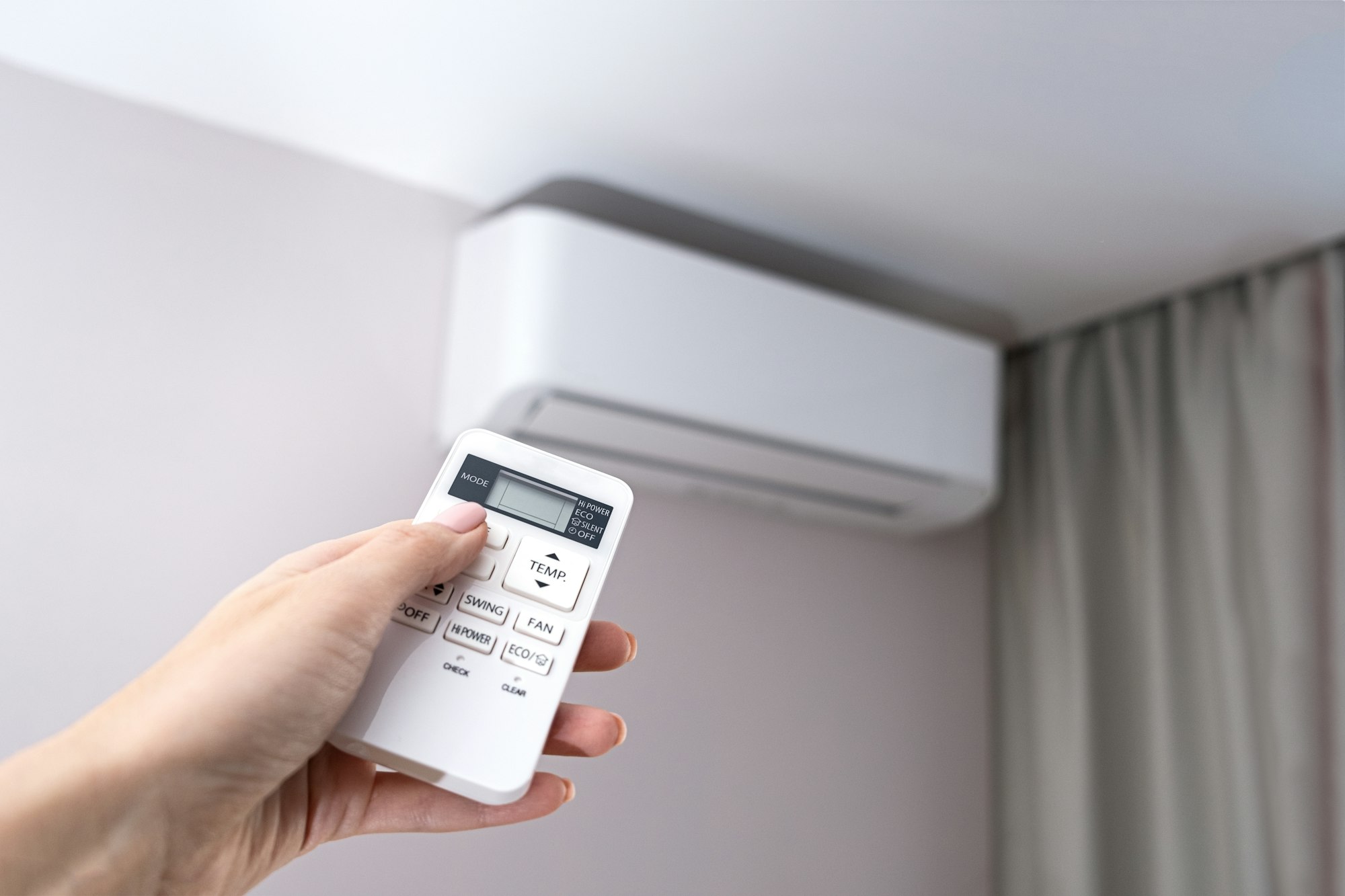 Adjusting the temperature of a split system air conditioner with a remote control