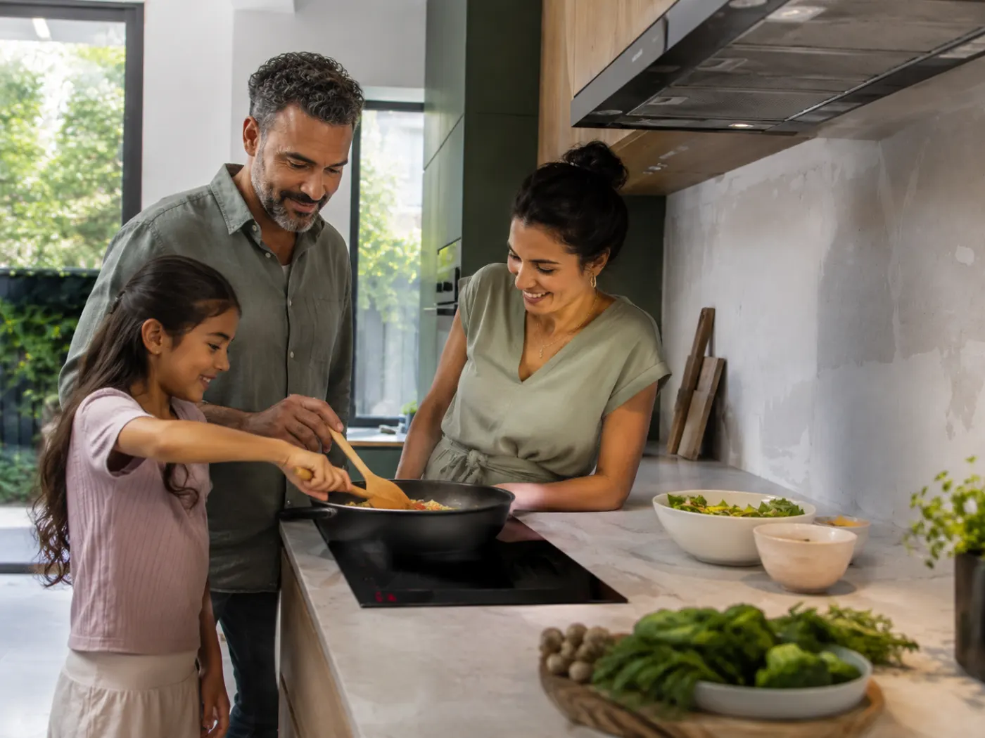 Family cooking together on an electric induction cooktop