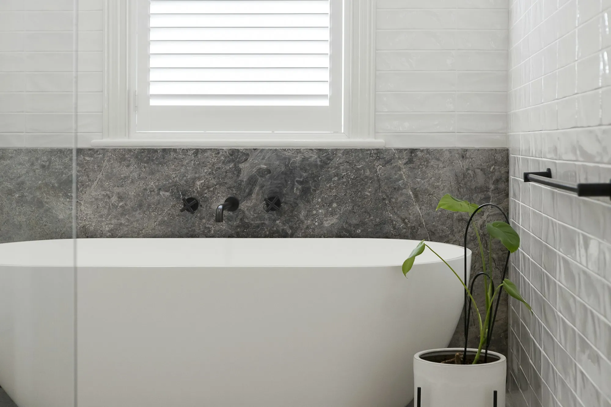 Modern bathroom with freestanding bath and black tapware