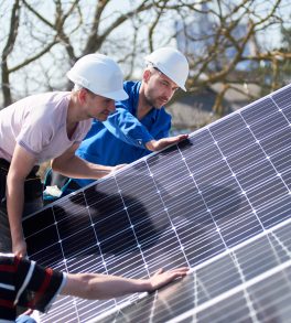 Accredited installers fitting a solar panel